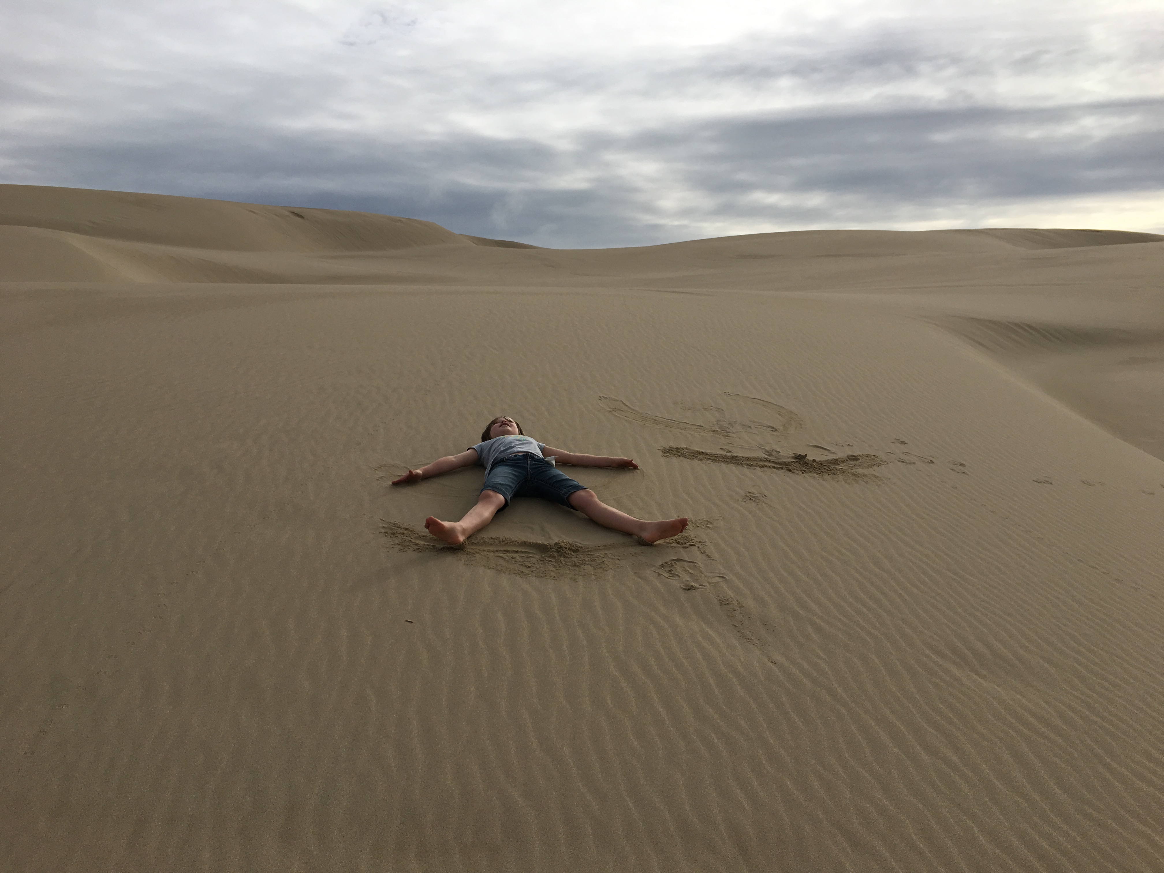 A child plays in the Oregon Dunes National Recreation Area