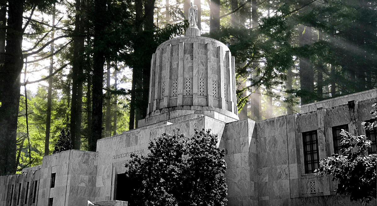 The Oregon Capitol building in black and white with a forest superimposed in the background
