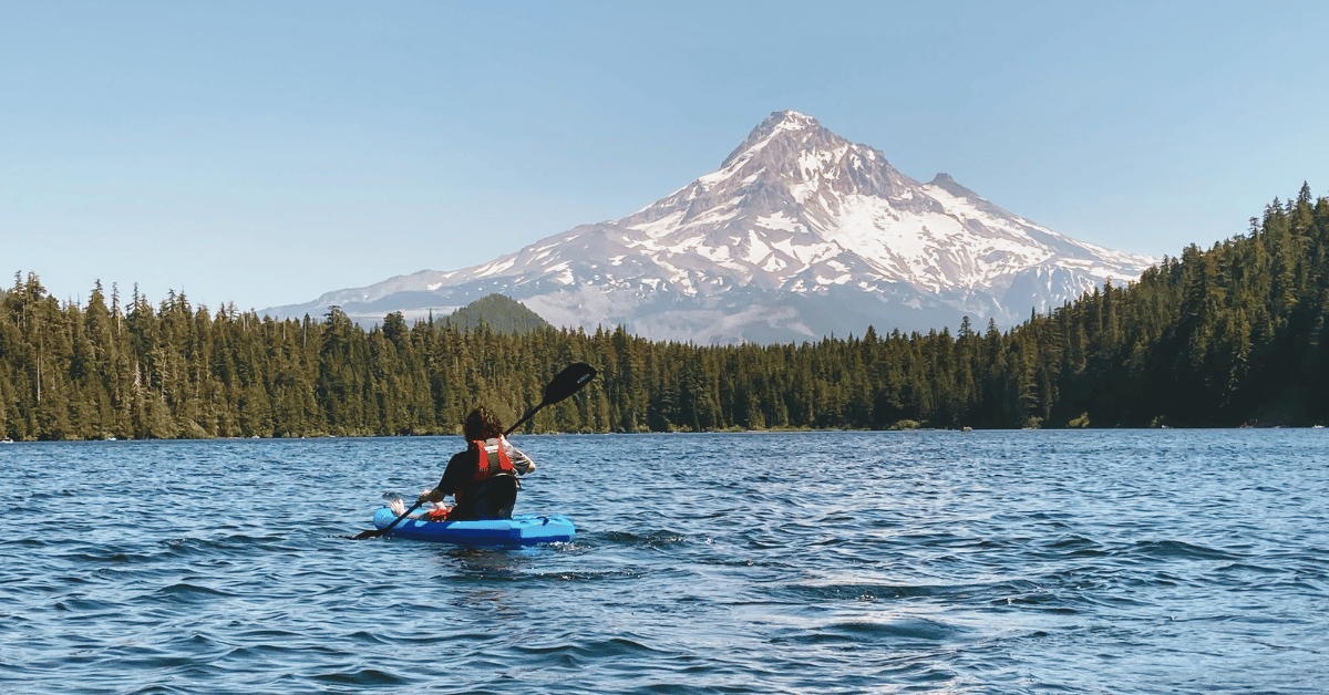 Paddling in a lake with Mount Hood towering in the distance. Photo of 